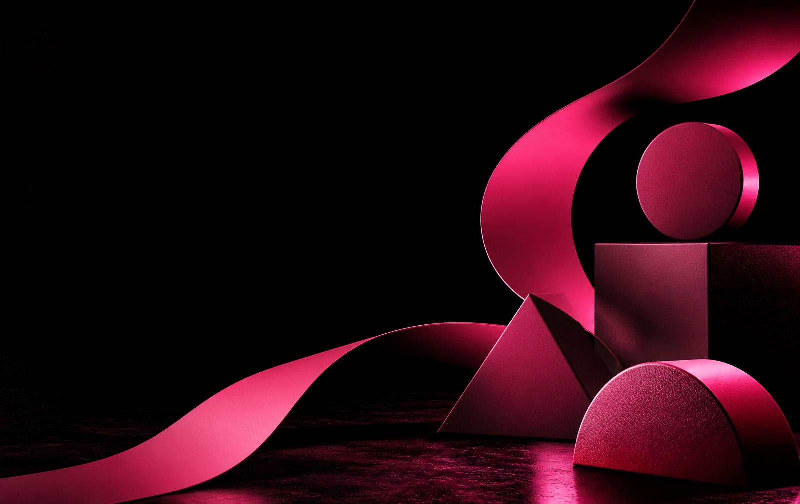 Bold pink geometric shapes on a black studio backdrop